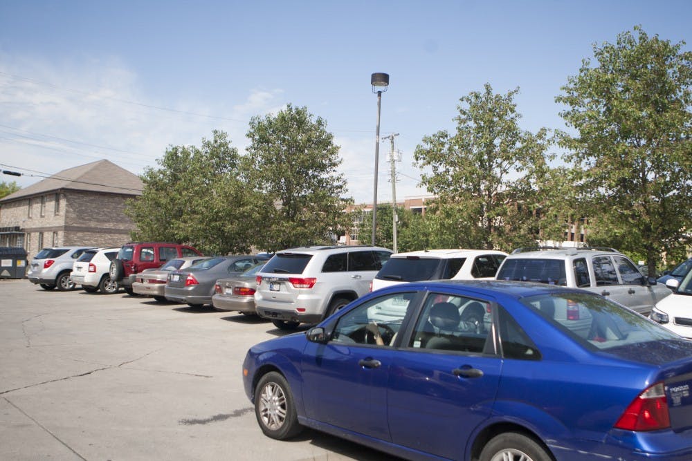Cars look for spaces to park in the parking lot behind Scotty's in the Village. DN FILE PHOTO JORDAN HUFFER 