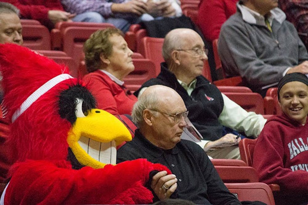 Charlie Cardinal holds the hand of a Ball State fan during the game Wednesday in Worthen Arena. DN PHOTO TAYLOR IRBY
