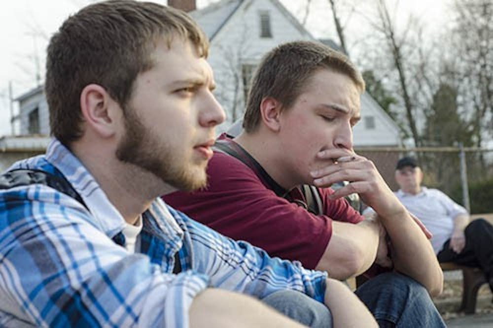 Aaron Huntley takes a drag off of his cigarette while he talks with Nick Solloway. A recent study by Ball State’s Global Health Institute showed that Indiana has the seventh highest smoking rate in the nation. DN PHOTO COREY OHLENKAMP