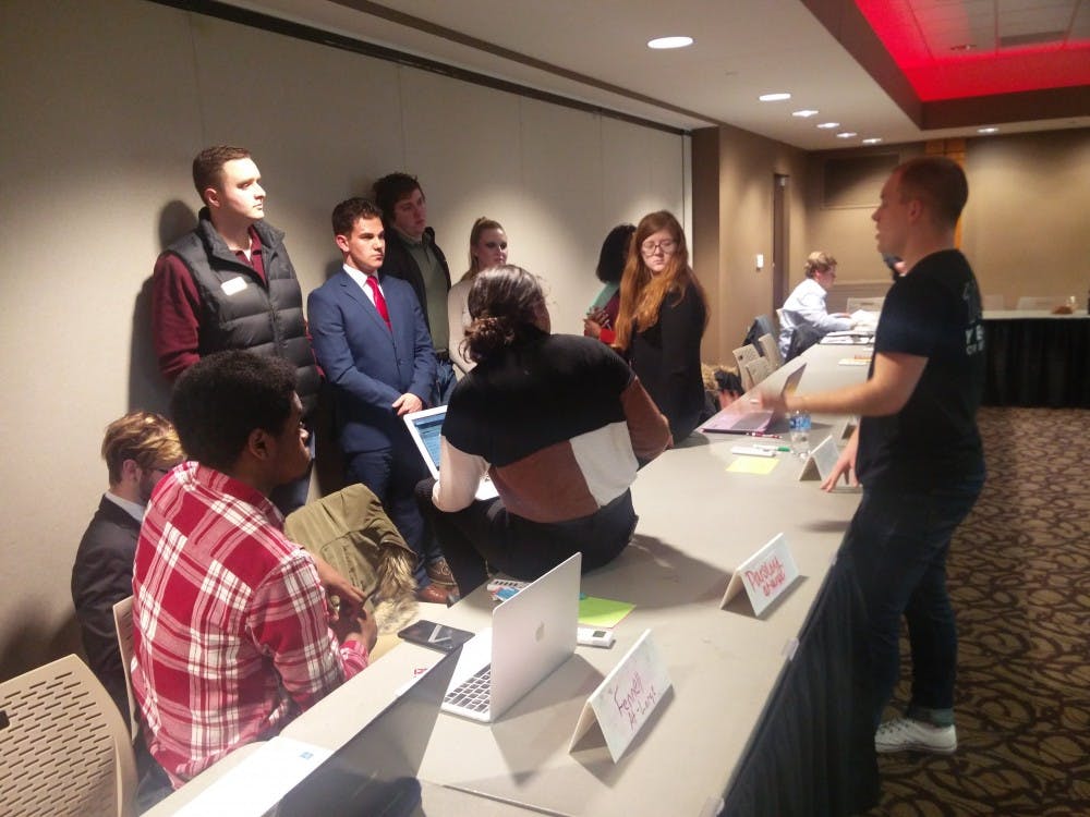 <p>Student Government Association's (SGA) At-Large caucus discusses with its senators during the senate meeting held Feb. 20, 2019, at the L. A. Pittenger Student Center ballroom. The senate passed a resolution to revise Ball State's emergency alert text system. <strong>Rohith Rao, DN</strong></p>