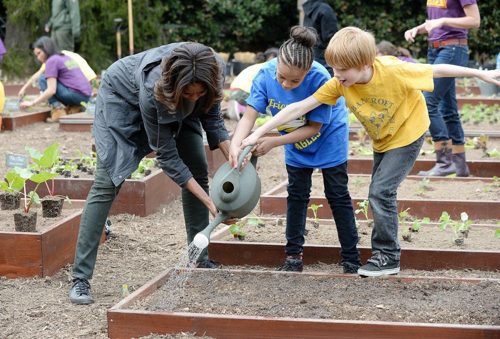 Michelle Obama and local students plant the White House kitchen garden on the White House