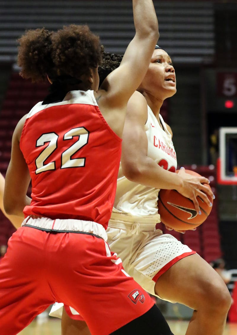 Ball State junior forward Oshlynn Brown drives the ball in while being guarded by Western Kentucky junior guard Sherry Porter during the Cardinals' game against the Hilltoppers Dec. 7, 2019, at John E. Worthen Arena. Brown was Ball States leading scorer with 22 points. Paige Grider, DN&nbsp;