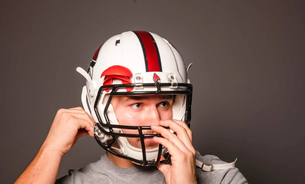 Redshirt freshman Mitchell Carter puts on his helmet Nov. 25, 2019. Jacob Musselman, DN Illustration