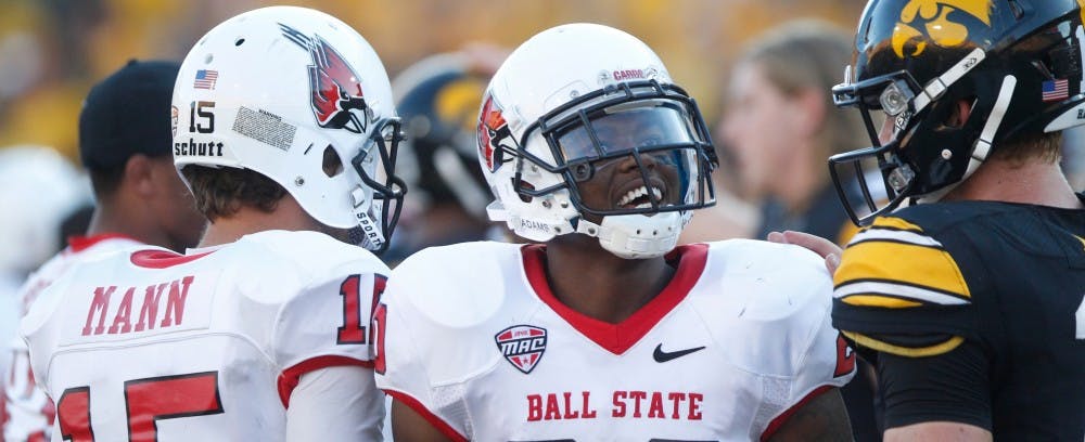 Ball State running back Jimmy Crumley talks to Iowa quarterback Jake Rudock after the game on Sept. 6 in Kinnick Stadium. Iowa defeated Ball State, 17-13. (The Daily Iowan/Rachael Westergard)