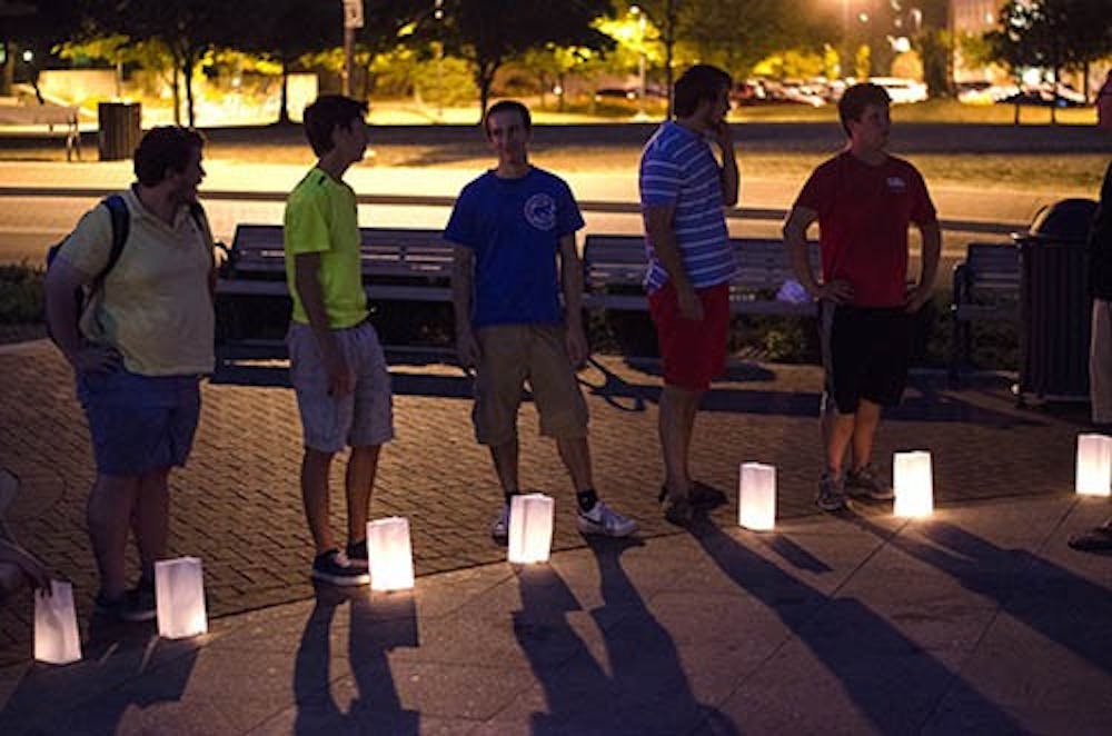 Students gather for the candlelight vigil to honor those who died in the Sept. 11, 2001, attacks. The students commemorated the anniversary with candle bags at the base of Shafer Tower with a brief moment of silence. DN PHOTO BREANNA DAUGHERTY