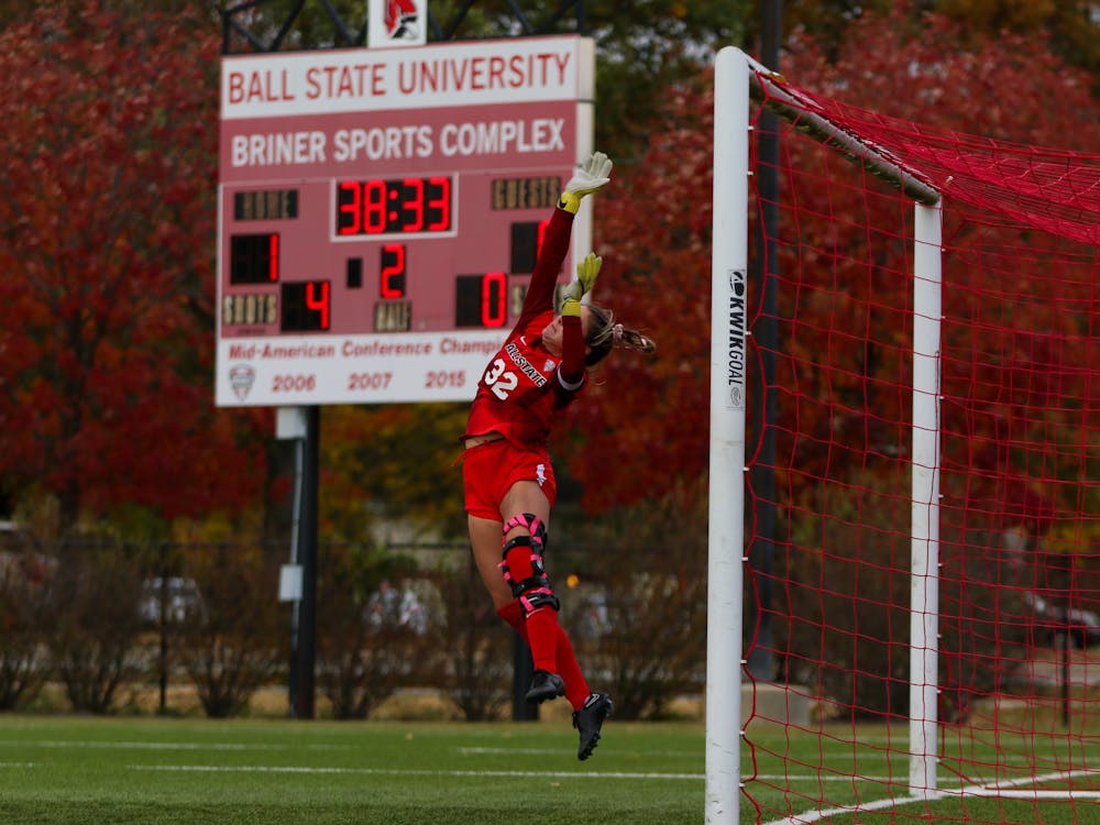 Second-year goalkeeper Bethany Moser in the air after successfully blocking a shot taken on Ball States goal in the second half of the game against Akron on Oct. 13 at Briner Sports Complex. Moser had a total of three saves during the match. Eve Green, DN