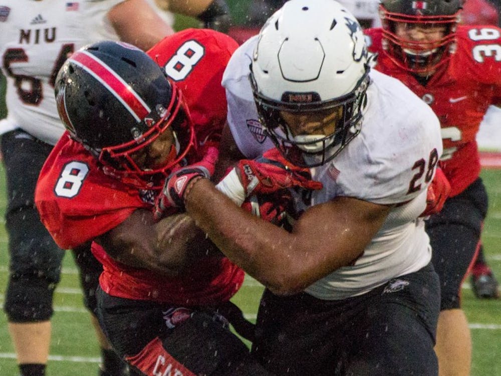 Ball State safety Corey Hall tackles Northern Illinois tailback Joel Bouagnon during the game on Oct. 1 in Scheumann Stadium. Ball State lost 31-24. Grace Ramey // DN