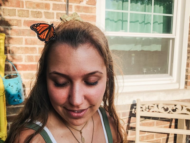 Taylor Smith helps her aunt release butterflies in her backyard. Smith’s aunt released a butterfly onto Smith’s hair where it sat like a hairpin for a moment before flying away. Taylor Smith, Photo Provided