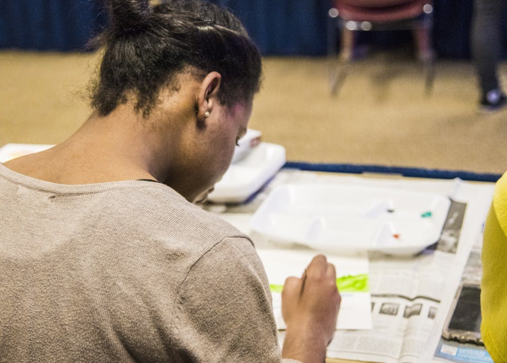 Ball State students paint water color pictures during the first event of the Asian American Student Association's month of events. The students received two pictures to paint; one was for practice. DN PHOTO RACHEL BRAMMER