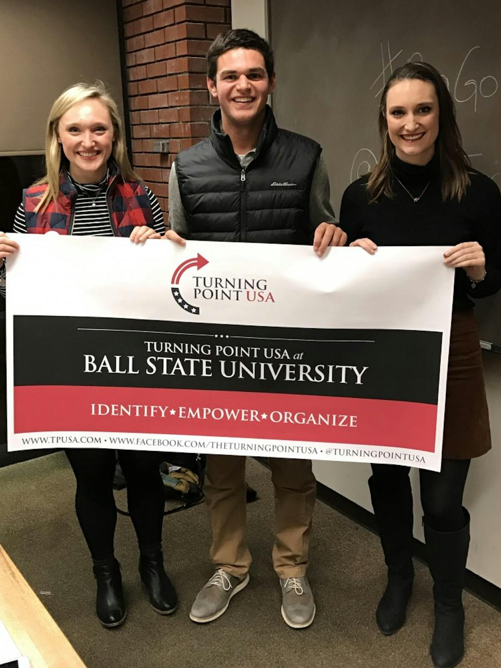 (From left) Caroline Owens, Luke Weise and Merre Owens display the new banner for Turning Point USA. TPUSA is a new club at Ball State that aims to&nbsp;talk about political issues in a civil, nonpartisan manner. Luke Weise // Photo Provided