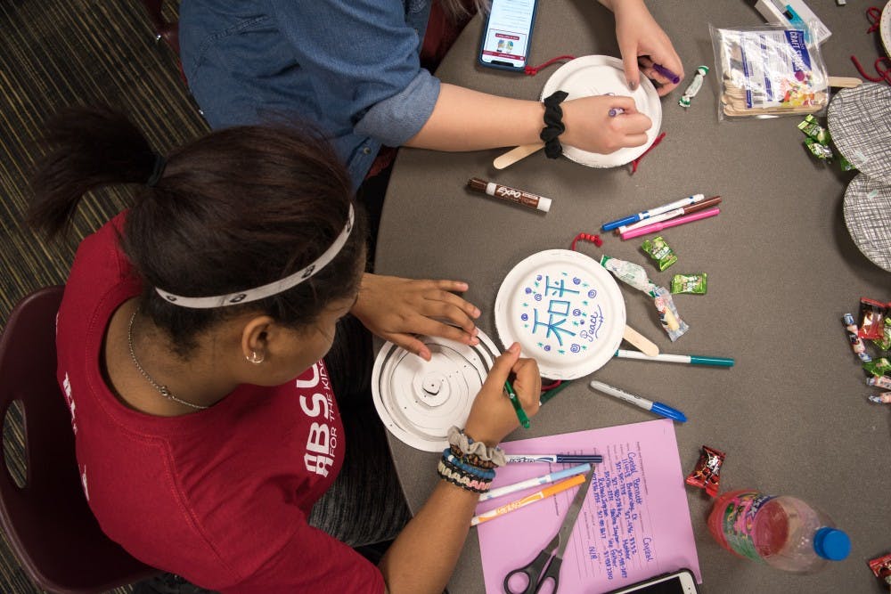 Freshman Crystal Bennett, medical technology major, decorates a plate drum to celebrate Lunar New Year on Feb. 19 at the L.A. Pittenger Student Center. Student decorate plate drum sticks for Lunar New Year 2018 to celebrate the year of the Dog at American Asian Student Association event. Stephanie Amador, DN