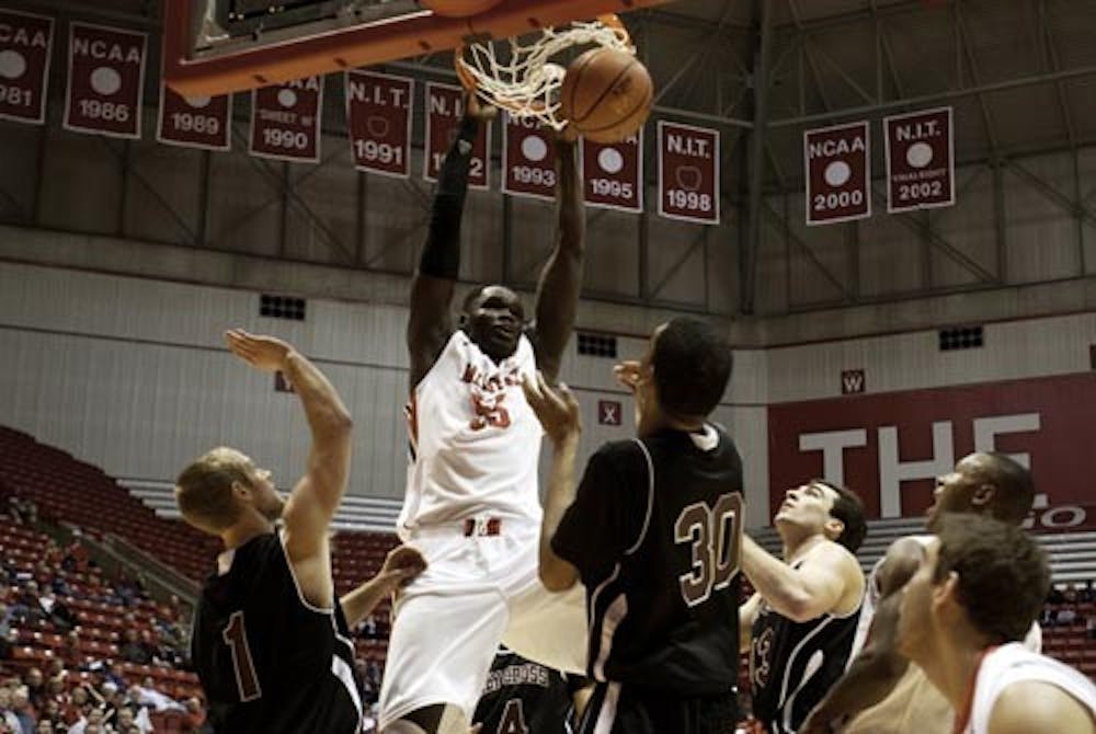 Junior Majok Majok successfully dunks the ball in Wednesday’s game against Holy Cross. The Cardinals defeated the Crusaders 76-57. DN PHOTO RJ RICKER
