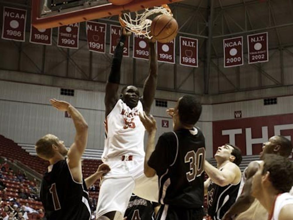 Junior Majok Majok successfully dunks the ball in Wednesday’s game against Holy Cross. The Cardinals defeated the Crusaders 76-57. DN PHOTO RJ RICKER