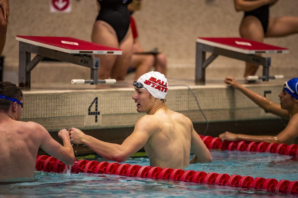Ball State freshman swimmer Joey Garberick fist bumps a teammate Nov. 6, 2020, at Lewellen Aquatic Center. Garberick is second in program history for 100 breaststroke. Ball State Athletics, Photo Provided