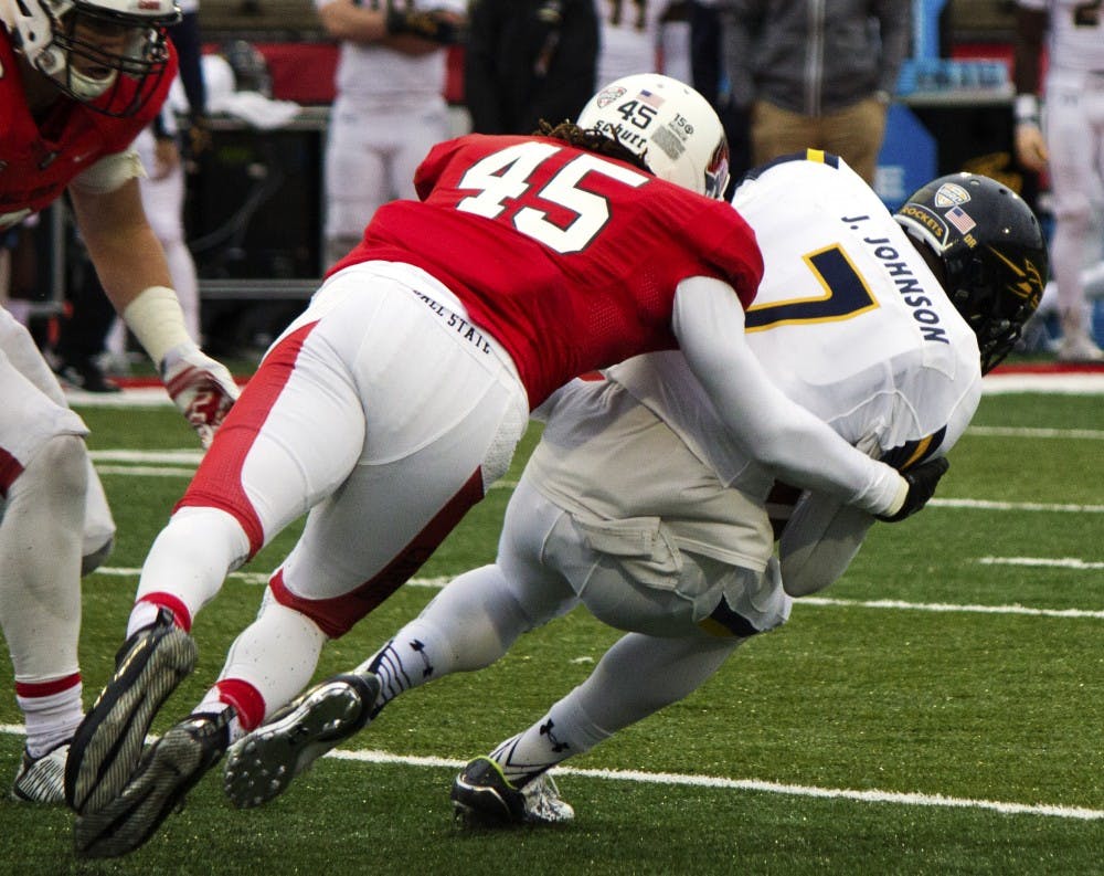 Ball State freshman cornerback Lamont McPhatter tackles Toledo University’s junior defensive back Delando Johnson during the homecoming game on Oct. 3 at Sheumann Stadium. (Grace Ramey)