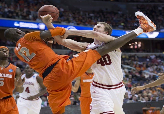 Syracuse center Baye Keita (12) fouls Indiana forward Cody Zeller (40) in the second half of an NCAA Tournament East Regional semifinal at the Verizon Center in Washington, D.C., Thursday, March 28, 2013. Syracuse defeated Indiana, 61-50. (Harry E. Walker/MCT)