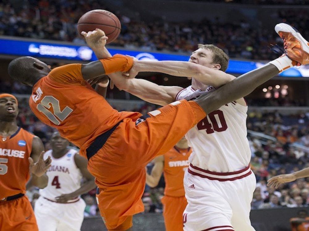 Syracuse center Baye Keita (12) fouls Indiana forward Cody Zeller (40) in the second half of an NCAA Tournament East Regional semifinal at the Verizon Center in Washington, D.C., Thursday, March 28, 2013. Syracuse defeated Indiana, 61-50. (Harry E. Walker/MCT)