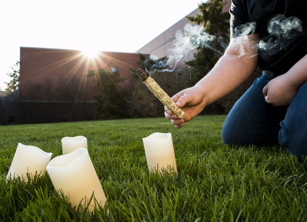 A student sets up a North American Wiccan spring sage blessing. The ritual is a celebration bringing in the new season after winter. DN PHOTO TAYLOR IRBY