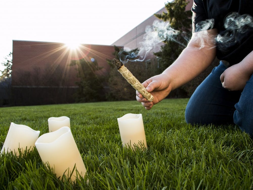 A student sets up a North American Wiccan spring sage blessing. The ritual is a celebration bringing in the new season after winter. DN PHOTO TAYLOR IRBY