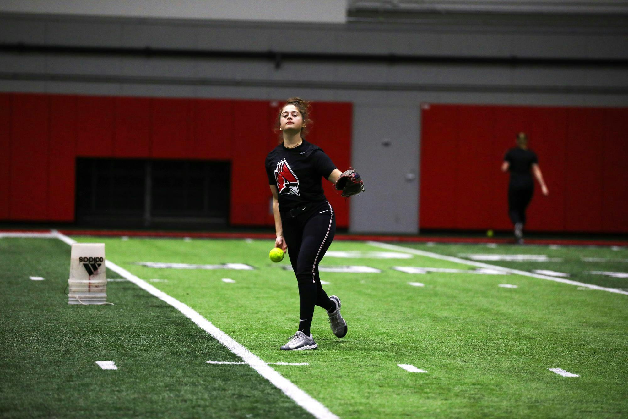 Sophomore pitcher Bridie Murphy pitches the ball during a practice Jan. 26 at Scheumann Family Indoor Practice Facility. Murphy had a 4.76 earned run average while pitching for the 2023 season. Mya Cataline, DN 