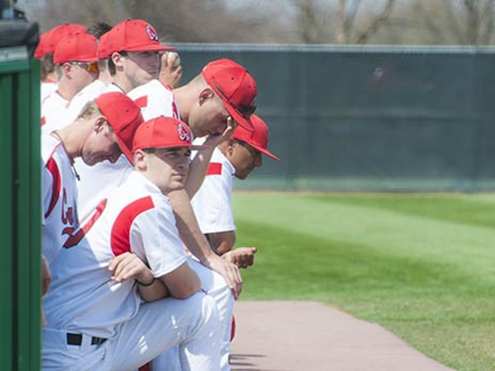 The team watches from the dug out as they take their turn to bat. An early lead for Ball State would fall apart and the team would finish with a loss of 7-5. DN PHOTO JONATHAN MIKSANEK