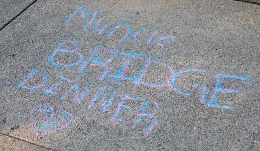 <p>Chalk art drawn on the sidewalk at the Muncie Bridge Dinner Sept. 20 on the Washington St. Bridge. The annual Muncie Bridge Dinner had both food and music for participants. <strong>Chase Martin, DN</strong>.</p>