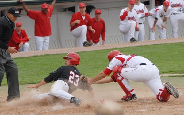 Catcher Zach Dygert tags out a runner at home plate during their game against Northern Illinois Sunday. Ball State's win puts them at 27-24 and 18-6 in the Mid-American Conference. DN PHOTO/JESS LANNING