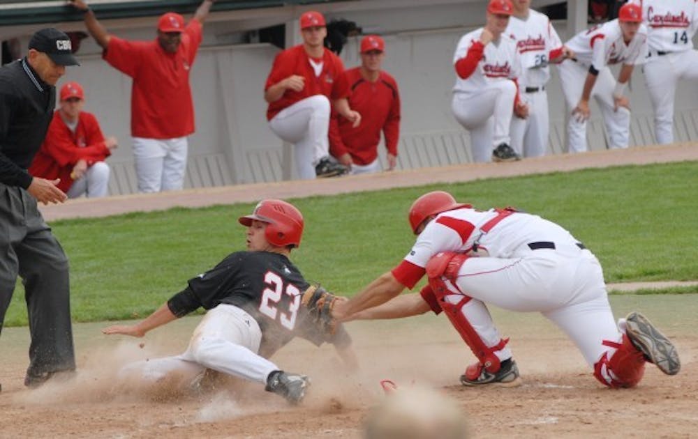 Catcher Zach Dygert tags out a runner at home plate during their game against Northern Illinois Sunday. Ball State's win puts them at 27-24 and 18-6 in the Mid-American Conference. DN PHOTO/JESS LANNING