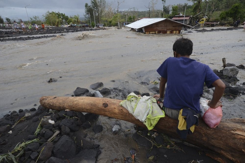 A man looks as floodwaters inundate an area as Typhoon Goni hit Daraga, Albay province, central Philippines, Sunday, Nov. 1, 2020. The super typhoon slammed into the eastern Philippines with ferocious winds early Sunday and about a million people have been evacuated in its projected path, including in the capital where the main international airport was ordered closed. (AP Photo)
