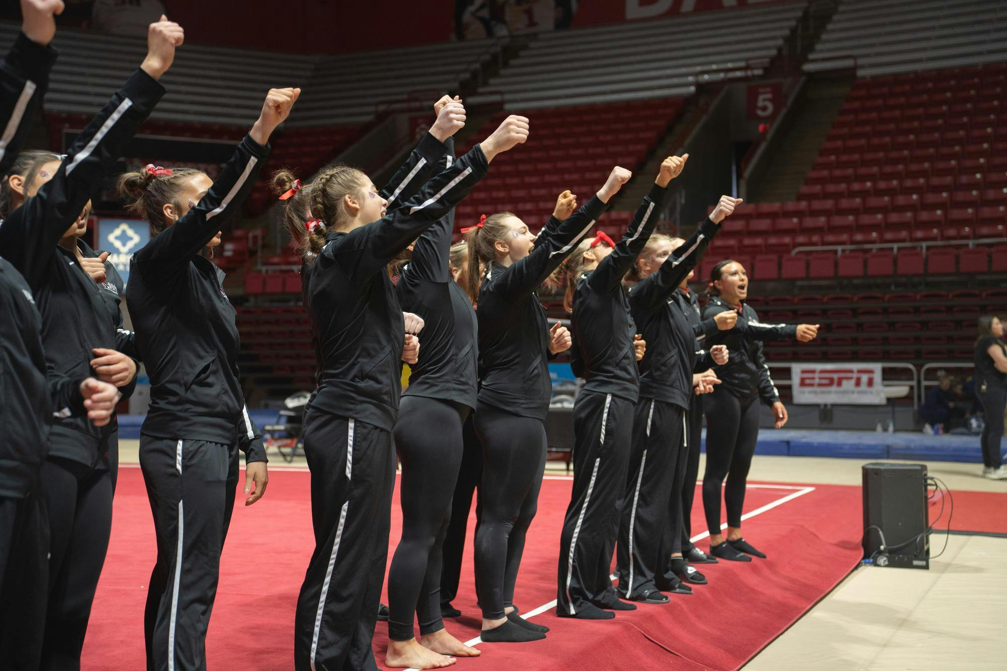 Ball State Women's Gymnastics cheers in unifrom at the end of the compeititon against Kent State Feb. 4 at Worthen Arena. The Cardinals won 196.075 vs 195.525. Kate Tilbury, DN