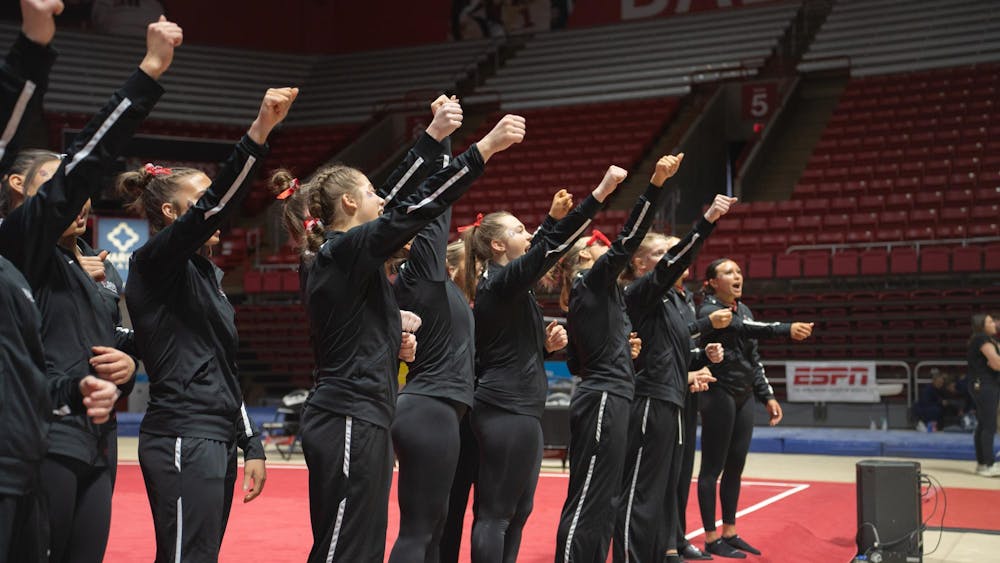 Ball State Women's Gymnastics cheers in unifrom at the end of the compeititon against Kent State Feb. 4 at Worthen Arena. The Cardinals won 196.075 vs 195.525. Kate Tilbury, DN