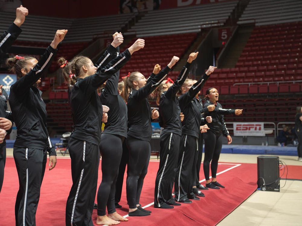 Ball State Women's Gymnastics cheers in unifrom at the end of the compeititon against Kent State Feb. 4 at Worthen Arena. The Cardinals won 196.075 vs 195.525. Kate Tilbury, DN