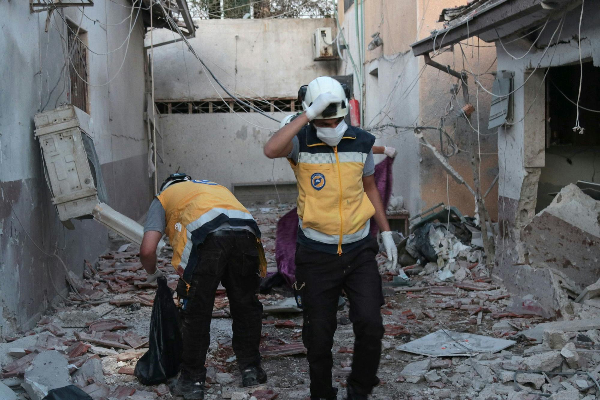 Members of Syria's Civil Defence service sift through the rubble at Al-Shifaa hospital following shelling of the rebel-held city of Afrin in northern Syria, on June 12, 2021. Shelling of the rebel-held city of Afrin in northern Syria killed at least 16 people, many of them when a hospital was struck, a war monitor said. (BAKR ALKASEM/AFP via Getty Images/TNS)