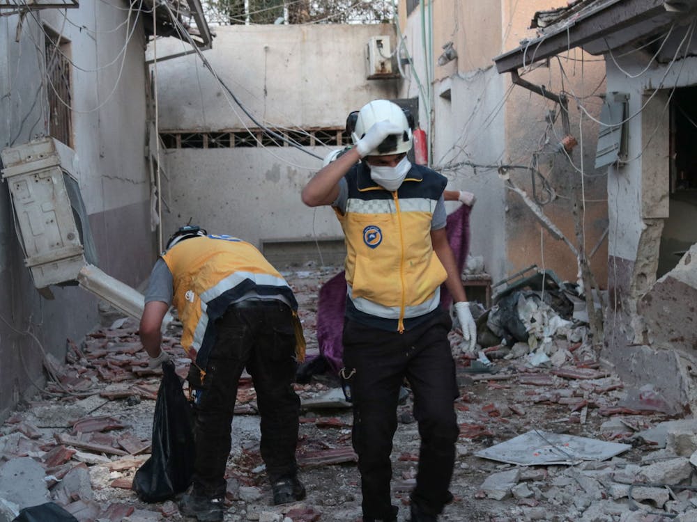 Members of Syria's Civil Defence service sift through the rubble at Al-Shifaa hospital following shelling of the rebel-held city of Afrin in northern Syria, on June 12, 2021. Shelling of the rebel-held city of Afrin in northern Syria killed at least 16 people, many of them when a hospital was struck, a war monitor said. (BAKR ALKASEM/AFP via Getty Images/TNS)