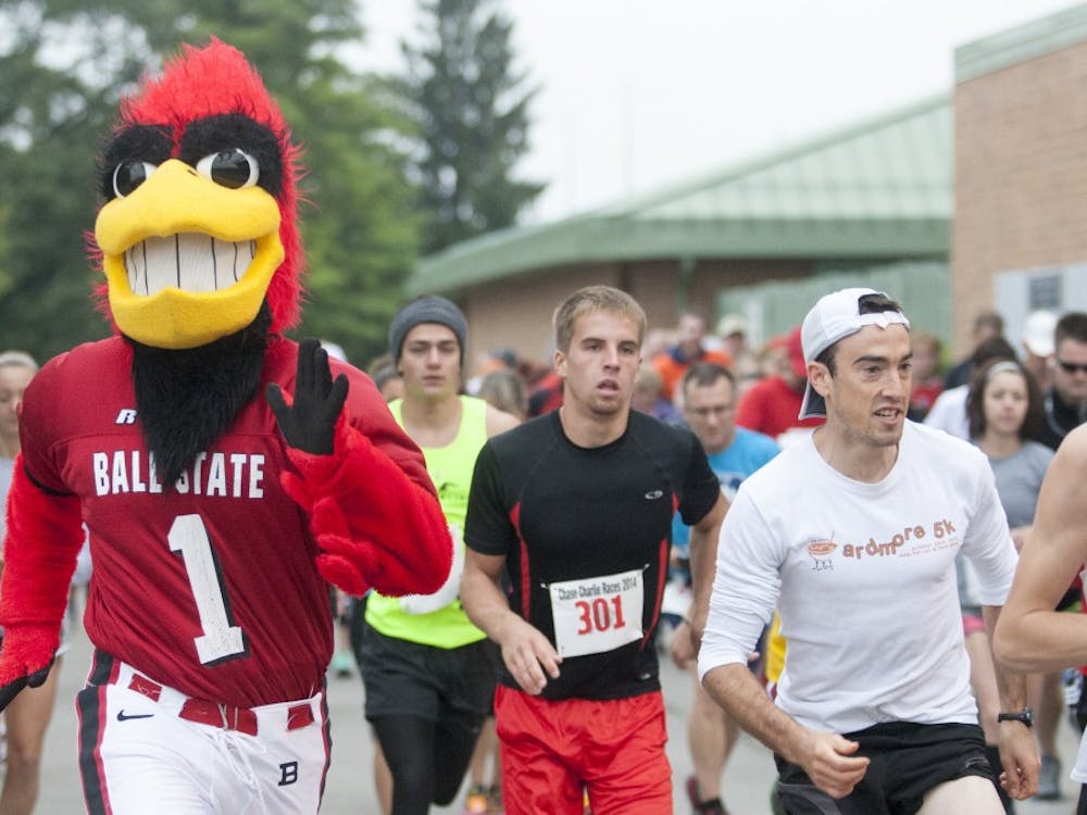 Charlie Cardinal takes off from the starting line with the other runners during the Chase Charlie 5K Fun Run on Sept. 13. Over 150 people participated in this year's run. DN PHOTO JORDAN HUFFER
