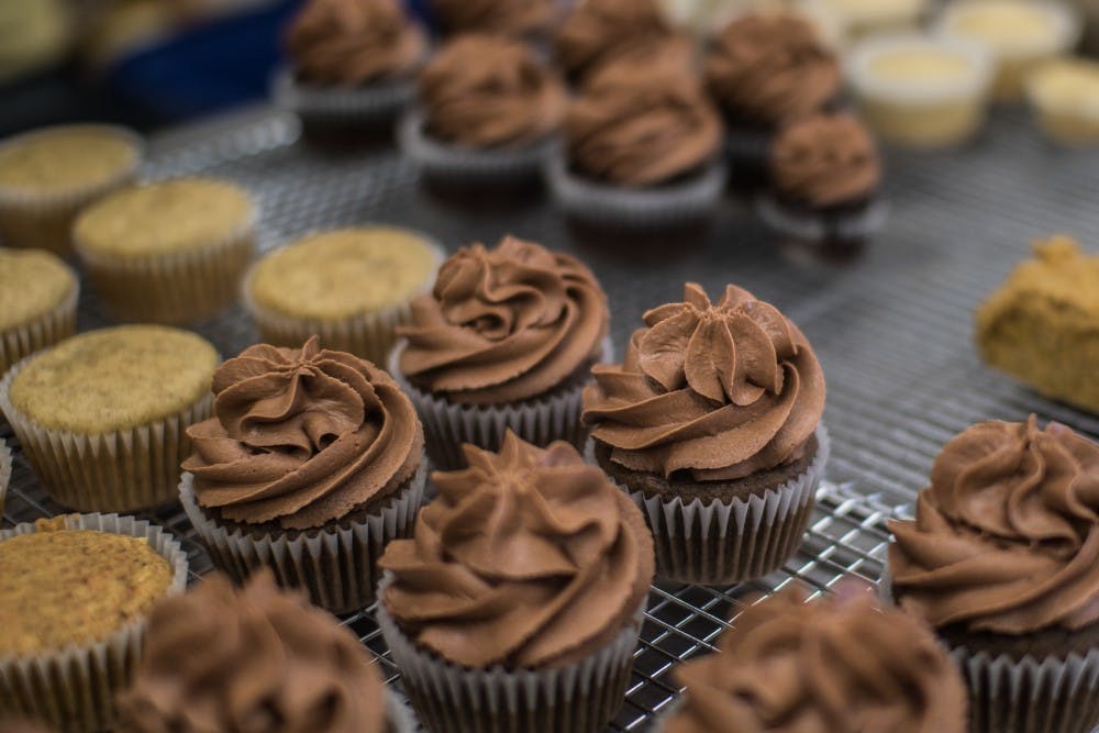 Amanda Reninger, owner of Sea Salt and Cinnamon, ices cupcakes on Feb. 23. Reninger bakes gluten free and vegan cupcakes and cookies for individuals and local businesses around Muncie, including The Caffeinery and the Woodworth dining hall.  The bakery doesn't have it's own store front, so she uses the Forest Park Senior Center kitchen to create her specialty treats. Reagan Allen // DN
