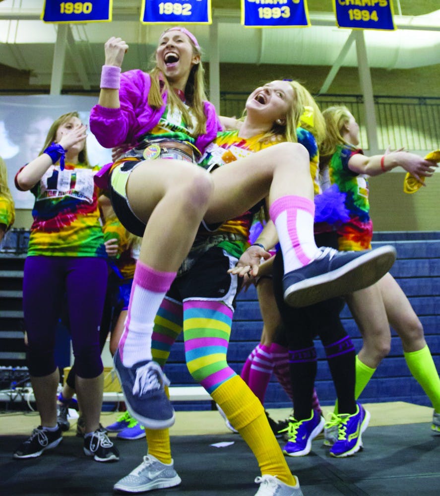 Public relations major and sophomore, Kylie Marcus, left, dances on stage during the Ball State Dance Marathon in Ball Gymnasium Feb. 16. DN PHOTO EMMA FLYNN