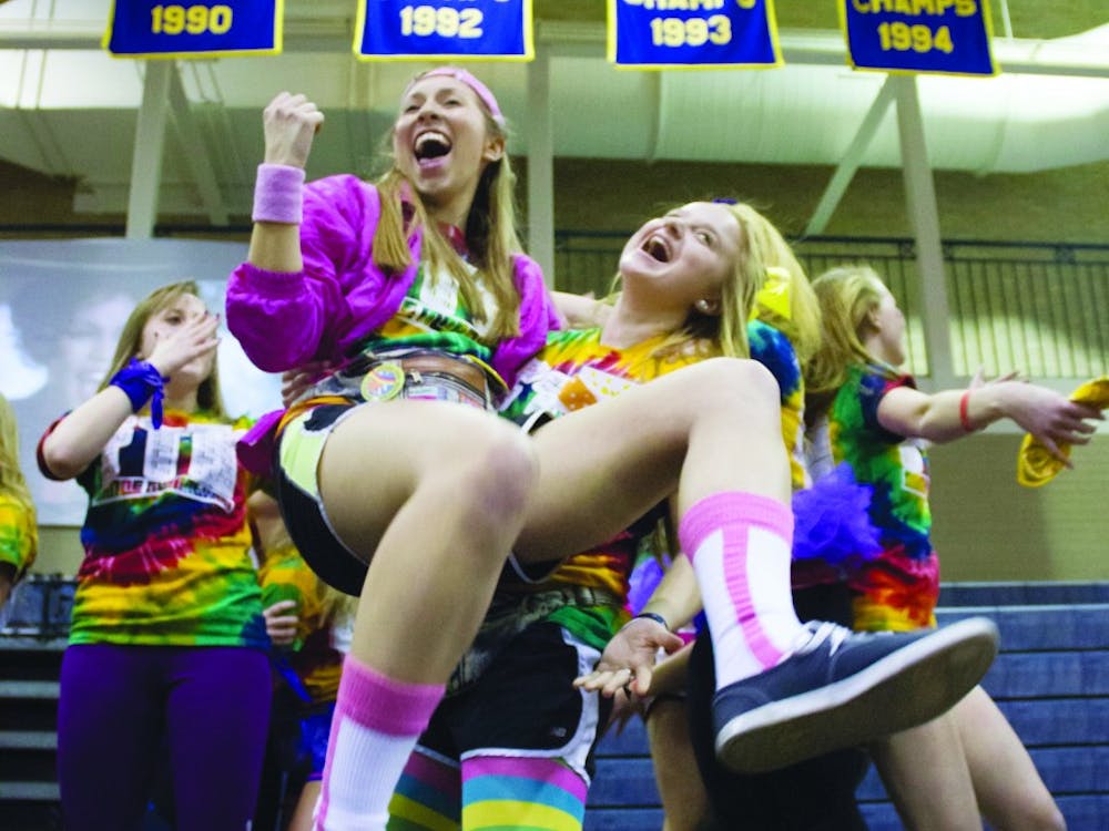 Public relations major and sophomore, Kylie Marcus, left, dances on stage during the Ball State Dance Marathon in Ball Gymnasium Feb. 16. DN PHOTO EMMA FLYNN