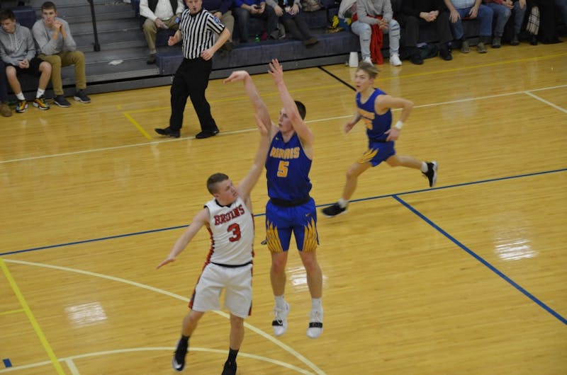 Burris senior Jackson Adamowicz shoots over a Blackford defender in a game against the Bruins on Feb. 21 at Ball Gymnasium. The Owls fell to the Bruins, 88-69. Jack Williams, DN&nbsp;