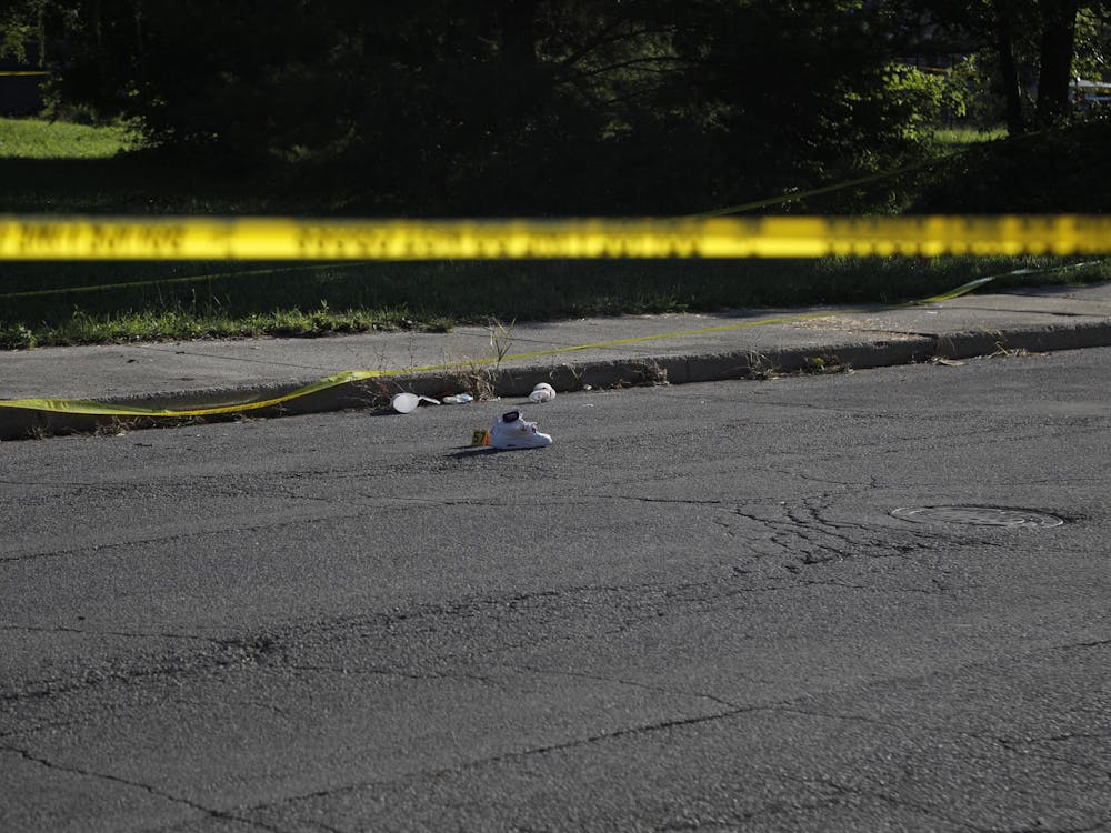 A shoe sits with a police marker next to it for evidence. Multiple were injured in the shooting. Elijah Poe, DN