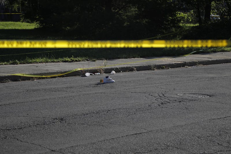 A shoe sits with a police marker next to it for evidence. Multiple were injured in the shooting. Elijah Poe, DN
