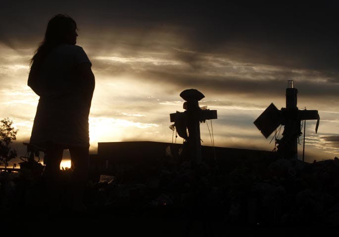 Sunrise is the most peaceful time of day to visit the public memorial site for the 12 killed last week in the Century 16 Theaters in Aurora, Colorado, on Saturday, July 28, 2012. Toys, flowers, balloons and signs are piling-up around the crosses as thousands of people stop by on a daily basis and pay their respects to the fallen. (Mark Boster/Los Angeles Times/MCT)