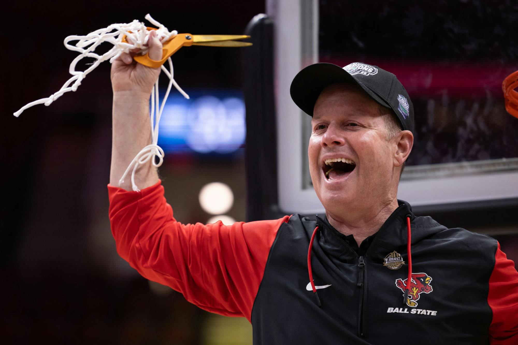 Ball State head coach Brady Sallee cuts the net after defeating Toledo on March 15, at Rocket Arena in Cleveland Oh. Ball State won the 2025 women's MAC Championship. Titus Slaughter, DN