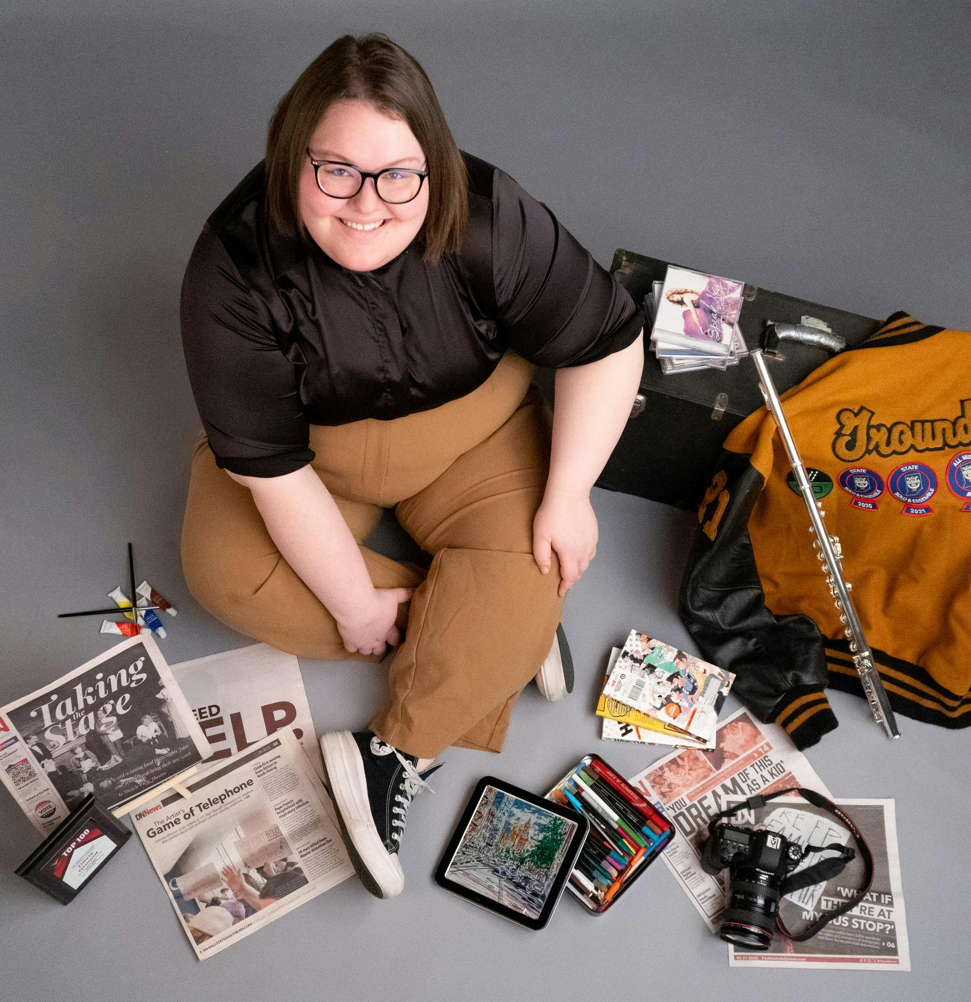 Liv Ground poses for a photo with items from high school and college April 15 in the Art and Journalism building. Isabella Kemper, DN