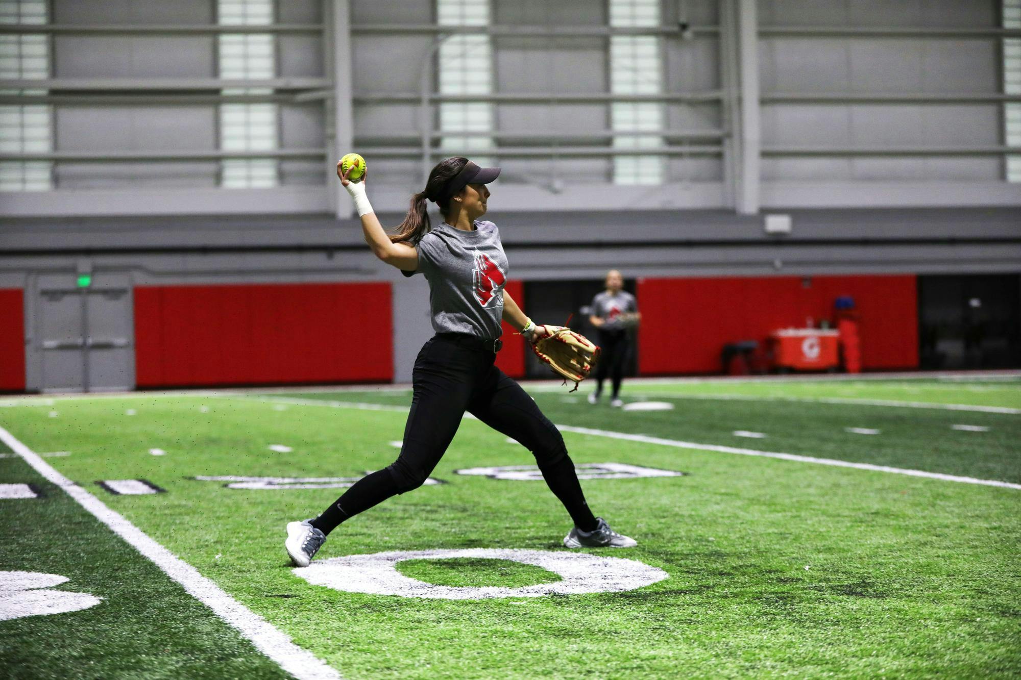 Senior outfielder Hannah Dukeman throws the ball during a practice Jan. 26 at Scheumann Family Indoor Practice Facility. Dukeman played in 76 of 135 total games of her Ball State career. Mya Cataline, DN