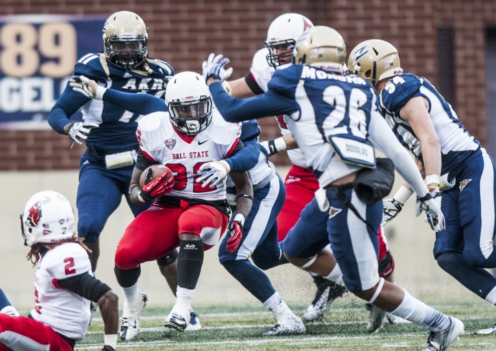 Junior running back Jahwan Edwards attempts to break away from the University of Akron line. DN PHOTO JONATHAN MIKSANEK