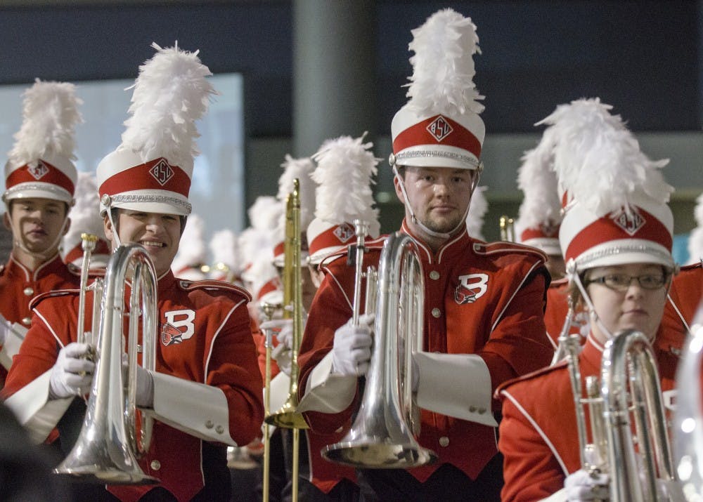Members of the Pride of Mid-America Marching Band cheer as they exit the hall during the mayor's luncheon Jan. 3 at the Mobile Convention Center in Mobile, Ala. DN PHOTO COREY OHLENKAMP