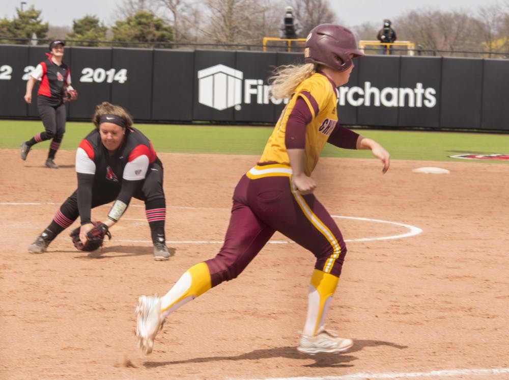 <p>Ball State sophomore Alyssa Rothwell, left, catches a ground ball while Central Michigan player Madison Kalina runs to first base during the first game against the Chippewas April 21 at the softball field at First Merchant’s Ballpark Complex. Kalina was called out. <strong>Briana Hale, DN</strong></p>