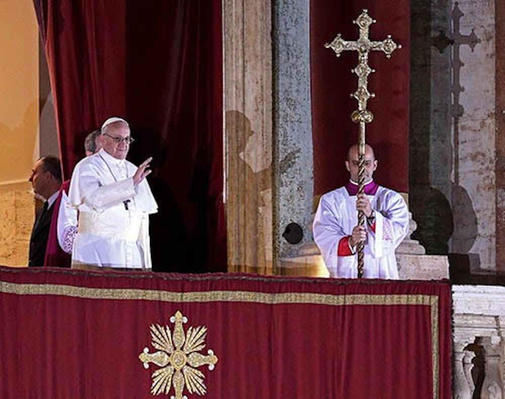 Pope Francis I stands on the central balcony of St. Peter