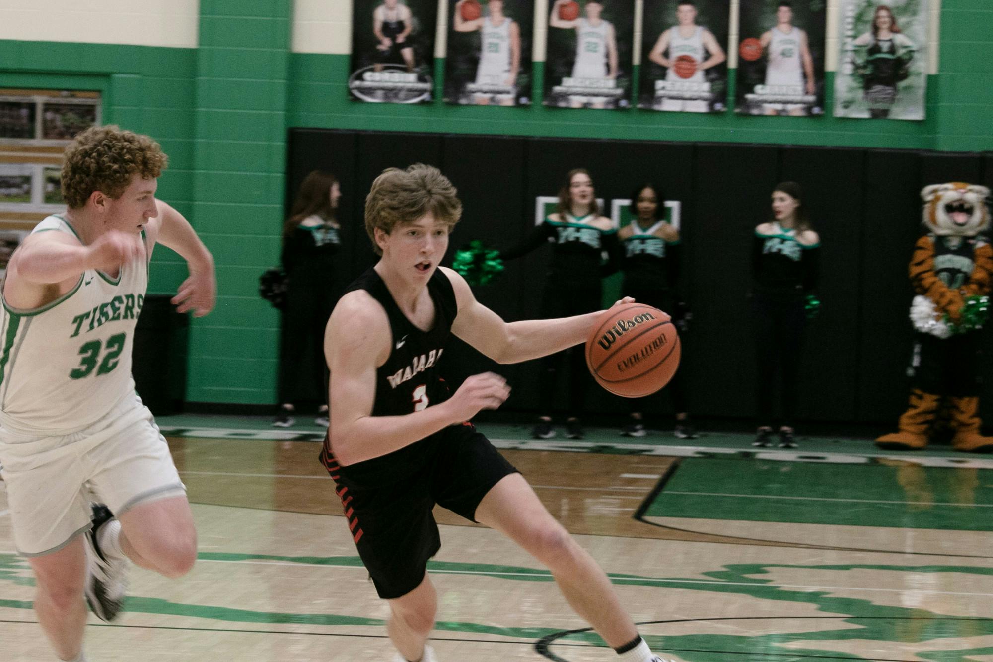 Wapahani Senior guard Aidan Franks dribbles past Yorktown senior guard Jacob Grim Feb. 18 at Yorktown High School. Zach Carter, DN